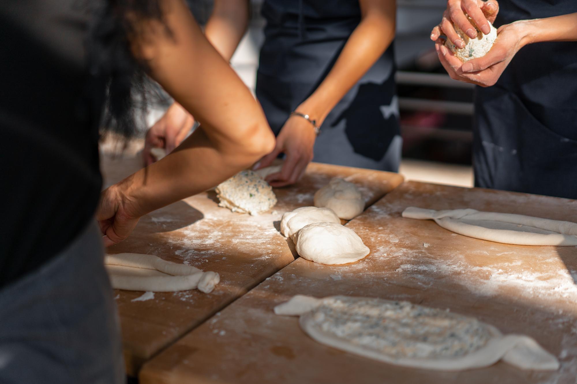 Hands kneading dough in a workshop